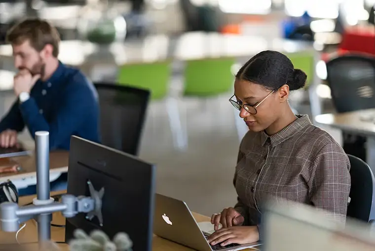 Girl behind computer working at desk