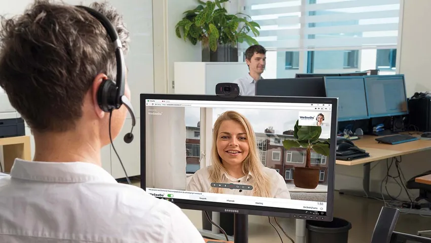 Twee mensen voeren op kantoor een videogesprek via WeSeeDo.